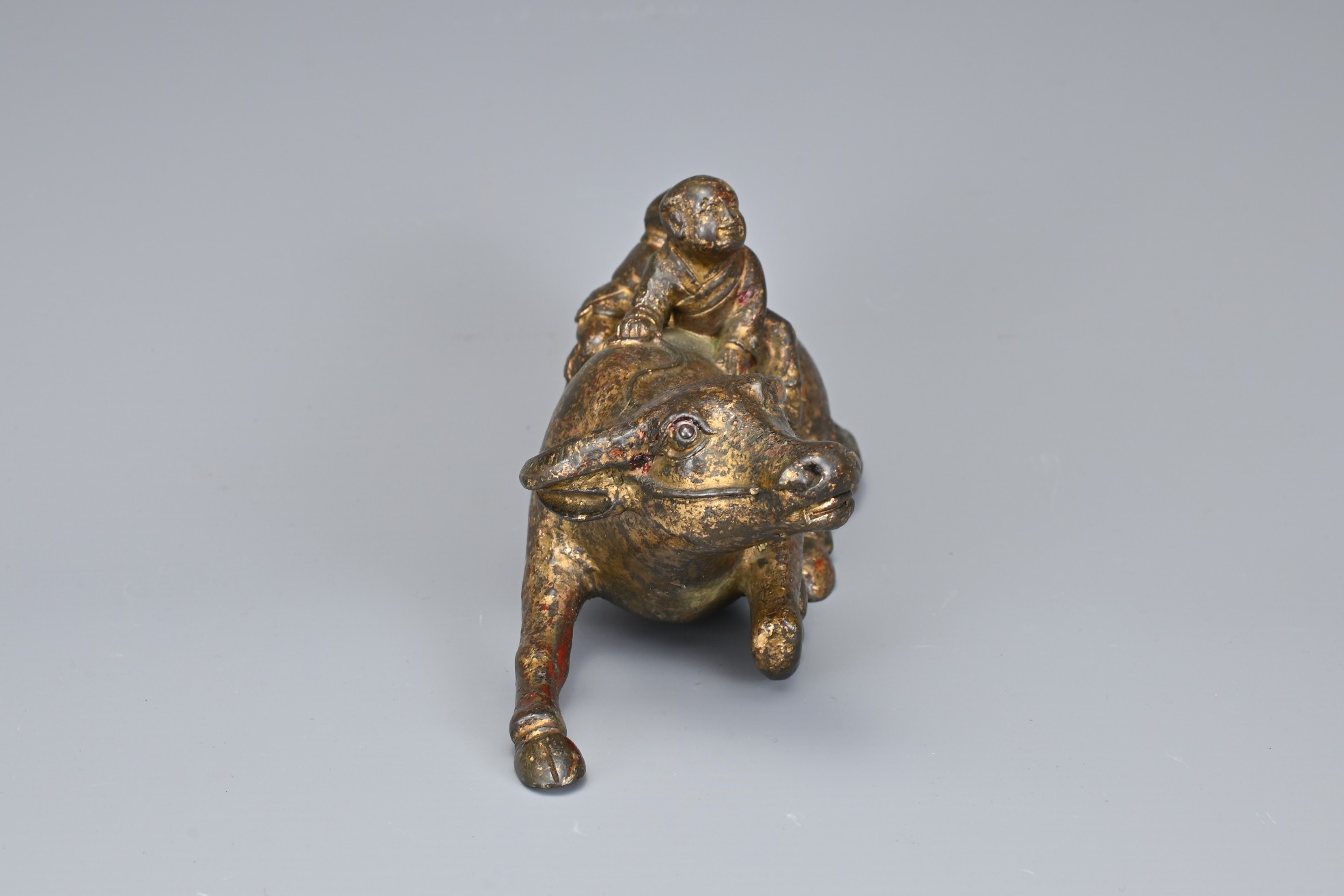 A CHINESE GILT BRONZE MODEL OF A BUFFALO AND BOYS. The recumbent buffalo wearing a rein with on - Image 3 of 7