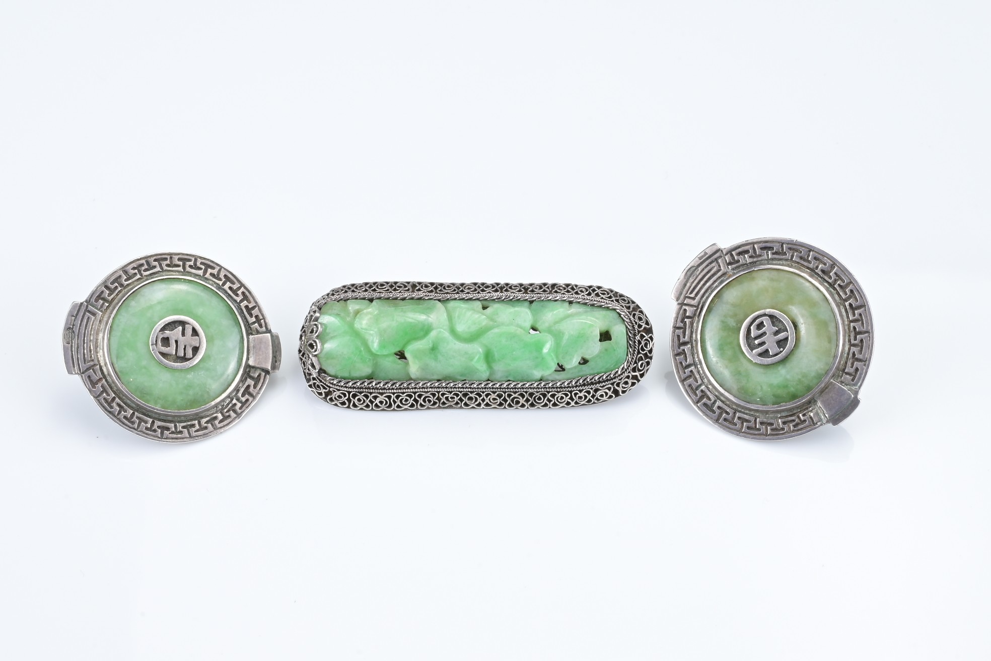 A CHINESE SILVER JADEITE BROOCH WITH CLIPS, 20TH CENTURY. The carved jadeite lotus leaf group - Image 2 of 4