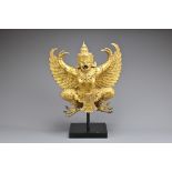 A LARGE THAI GILT BRONZE FIGURE OF GARUDA. The well modelled half man half bird figure wearing a