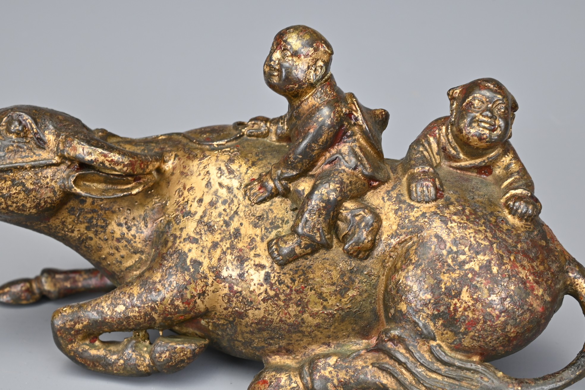 A CHINESE GILT BRONZE MODEL OF A BUFFALO AND BOYS. The recumbent buffalo wearing a rein with on - Image 7 of 7