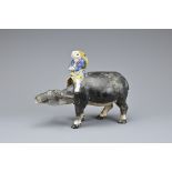 A CHINESE GLAZED CERAMIC FIGURE OF A BOY ON WATER BUFFALO, EARLY 20TH CENTURY. The separately
