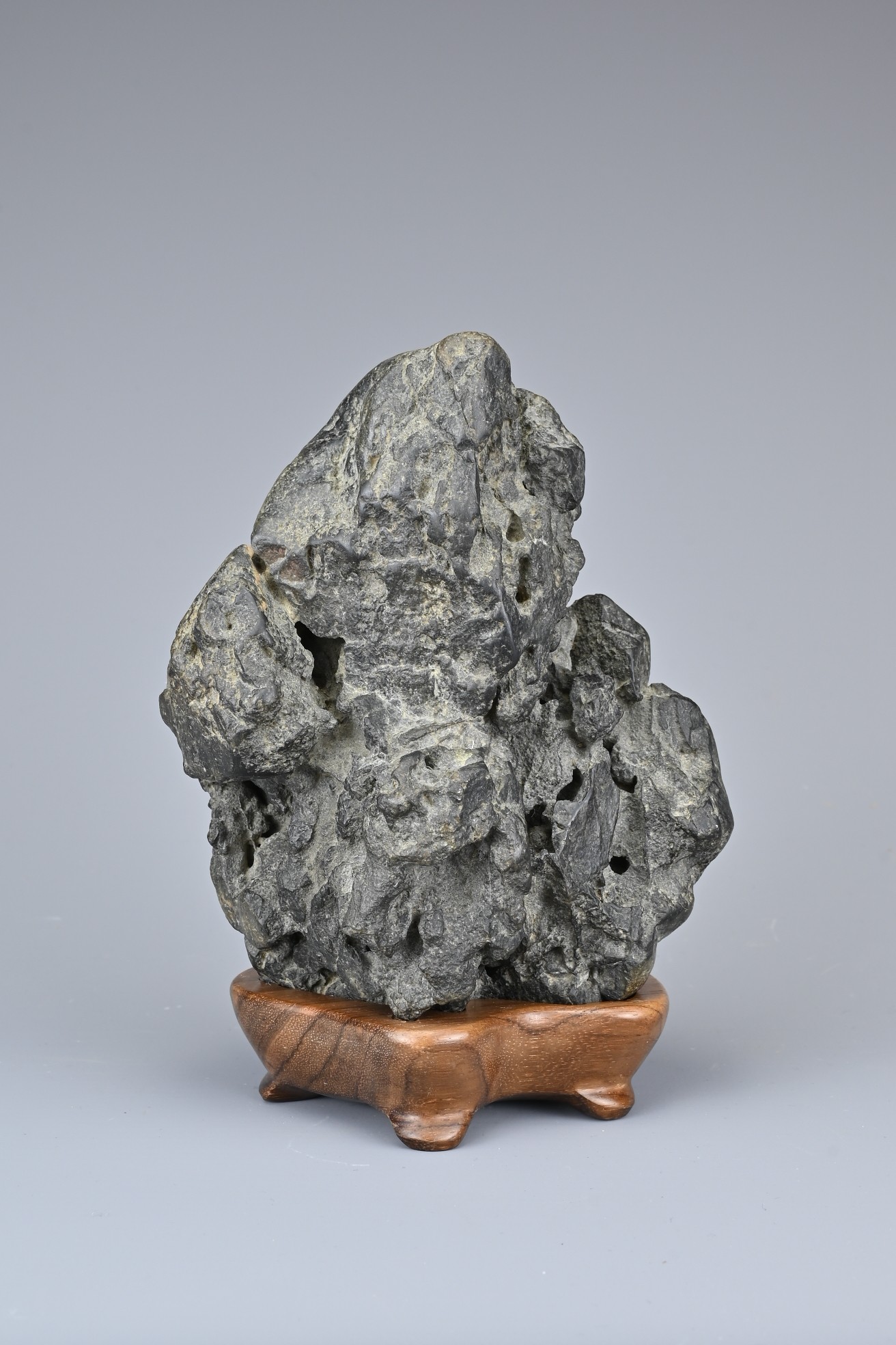 A CHINESE YING SCHOLAR ROCK, QING DYNASTY. Blackish-grey tone stone upright in the form of a