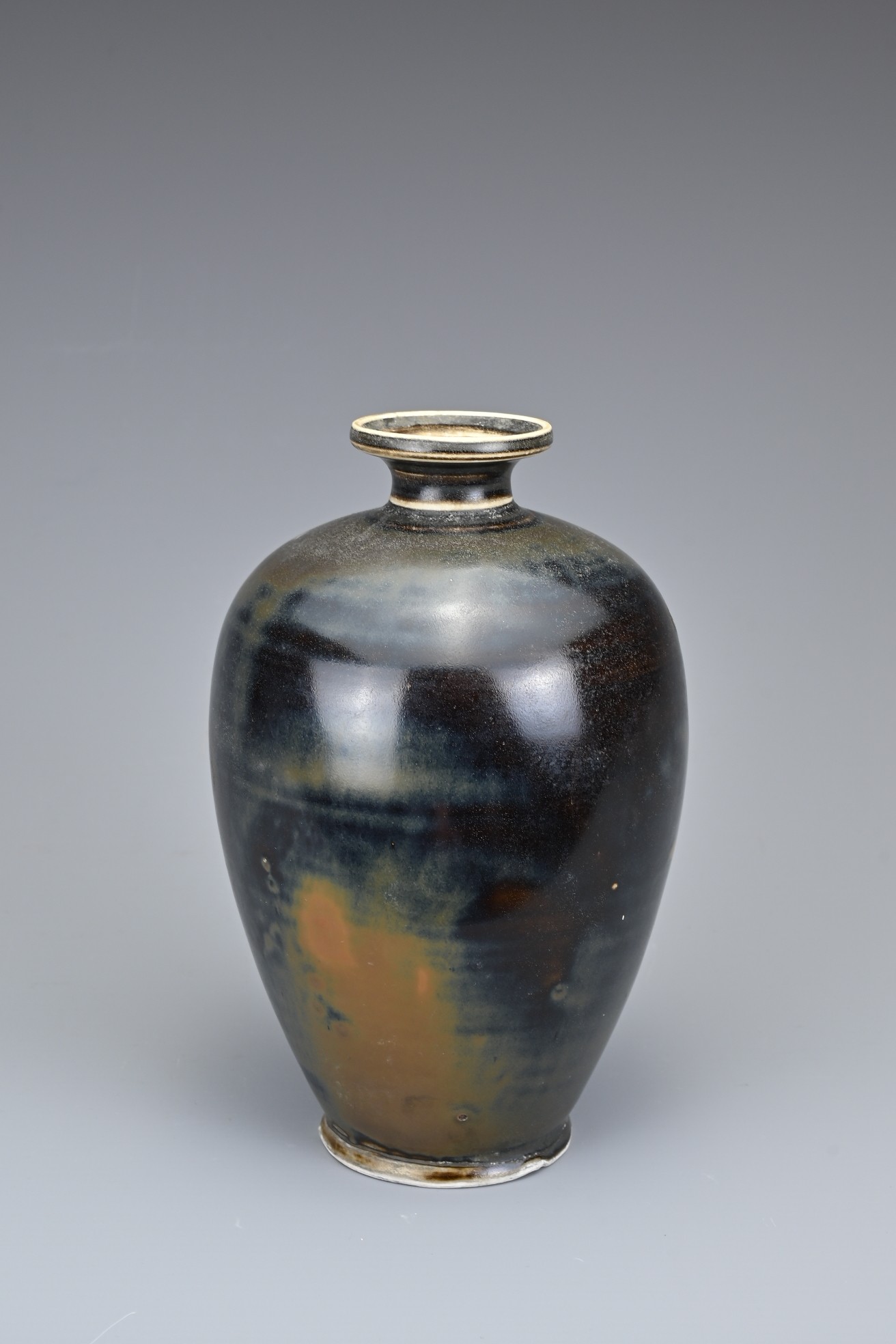 A CHINESE DING TYPE BROWN GLAZED BOTTLE VASE. Of ovoid form with everted rim covered in a dark brown - Image 3 of 5