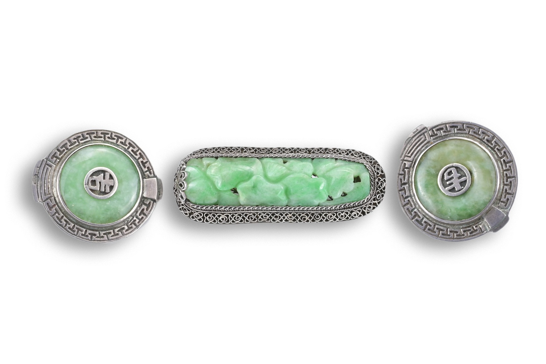A CHINESE SILVER JADEITE BROOCH WITH CLIPS, 20TH CENTURY. The carved jadeite lotus leaf group