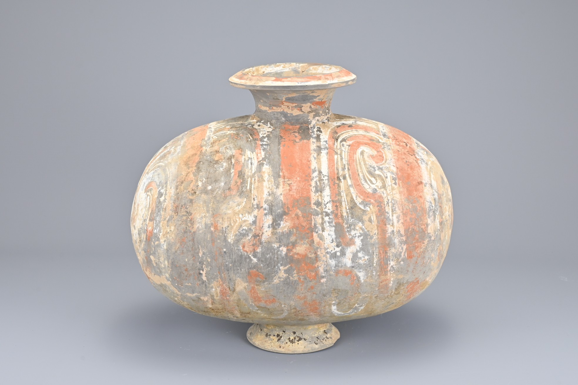 A CHINESE PAINTED POTTERY COCOON JAR, HAN DYNASTY. Referred to as a 'cocoon jar' due to the