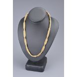 AN ANTIQUE 18CT YELLOW GOLD NECKLACE. The necklace with flat mesh design with fifteen clamped