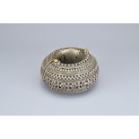 AN EASTERN METAL ITEM. Of cylindrical form with continuous banded pierced decoration and rope