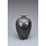 A CHINESE DING TYPE BROWN GLAZED BOTTLE VASE. Of ovoid form with everted rim covered in a dark brown