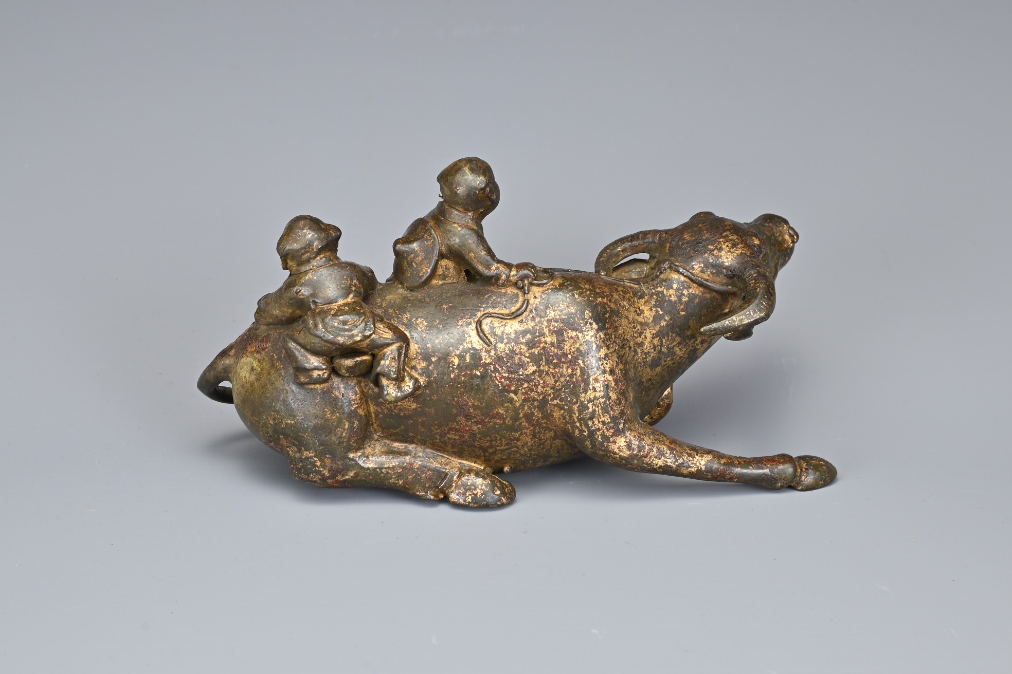 A CHINESE GILT BRONZE MODEL OF A BUFFALO AND BOYS. The recumbent buffalo wearing a rein with on - Image 4 of 7