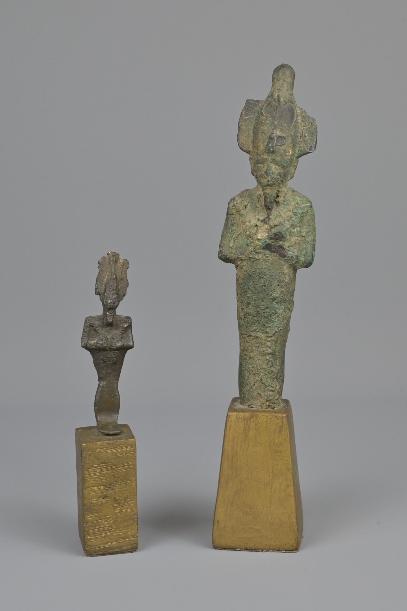 TWO EGYPTIAN BRONZE FIGURES OF OSIRIS, PROBABLY EGYPTIAN PTOLEMAIC OR ROMAN.