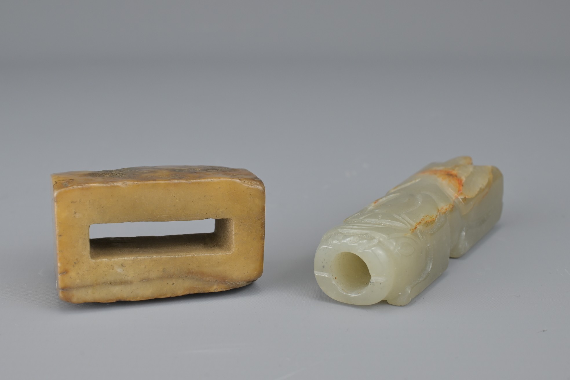 TWO CHINESE JADE FITTINGS. To include a celadon and russet animal form section of cylindrical - Image 2 of 6