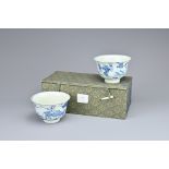 TWO CHINESE BLUE AND WHITE PORCELAIN TEA BOWLS. Each decorated with landscape scenes with farmer and