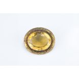 AN ANTIQUE CITRINE BROOCH. Faceted citrine cabochon mounted in yellow gold probably 9ct gold