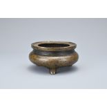 A CHINESE BRONZE TRIPOD CENSER. Of squat form with 'xing su zhai zhi' four-character mark in