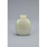 A CHINESE PALE CELADON JADE SNUFF BOTTLE. Of flattened ovoid form on short foot rim. 5.9cm height.