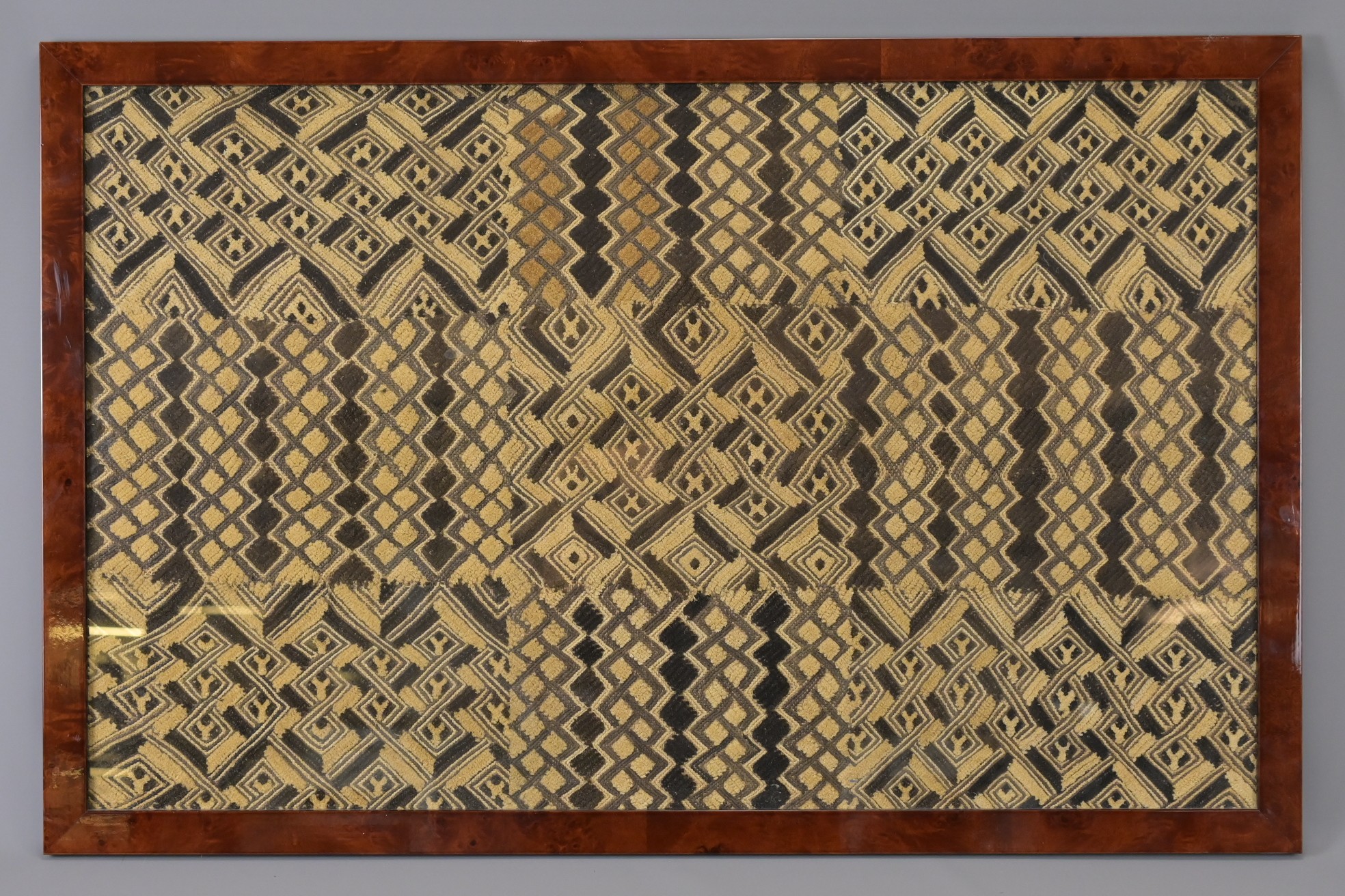 AN AFRICAN FRAMED EMBROIDERY, 20TH CENTURY, PERHAPS CONGOLESE. Woven with ivory and dark brown