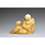 A CHINESE JADE CARVING OF LIU HAI AND TOAD. The figure reclining holding a cash coin and the toad on
