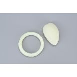 TWO CHINESE PALE CELADON JADE ITEMS. To include a round bamboo form bangle together with an uncarved