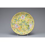 A CHINESE YELLOW GROUND FAMILLE ROSE DISH, 19TH CENTURY. Decorated to the interior with floral