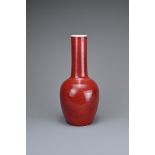 A CHINESE SANG DE BOEUF PORCELAIN BOTTLE VASE. Ovid body with a tall cylindrical neck covered in a