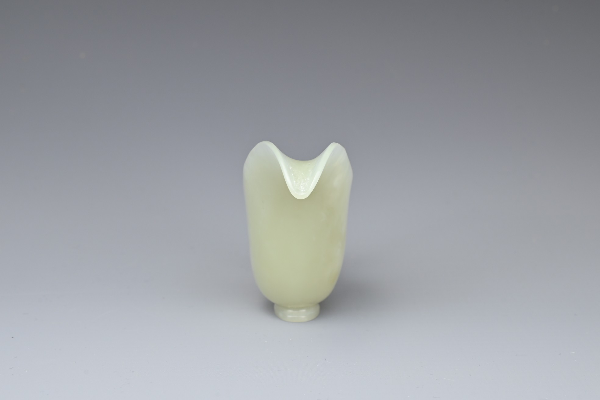 A CHINESE PALE CELADON JADE CUP. Of slender form with a looped handle and curved spout. 10.5cm - Image 3 of 7