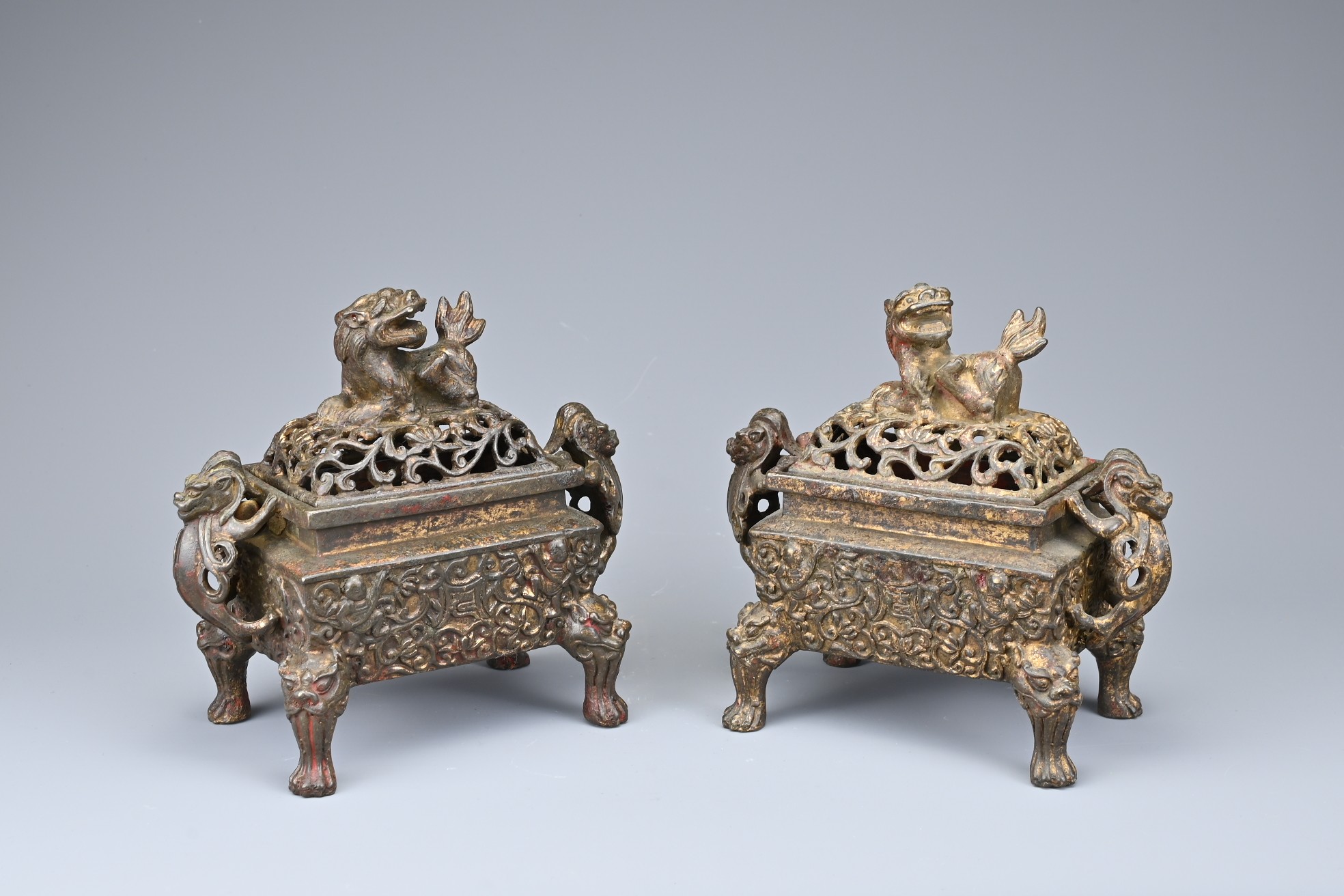 A PAIR OF CHINESE GILT BRONZE INCENSE BURNERS. Each or rectangular form with animal form handles and