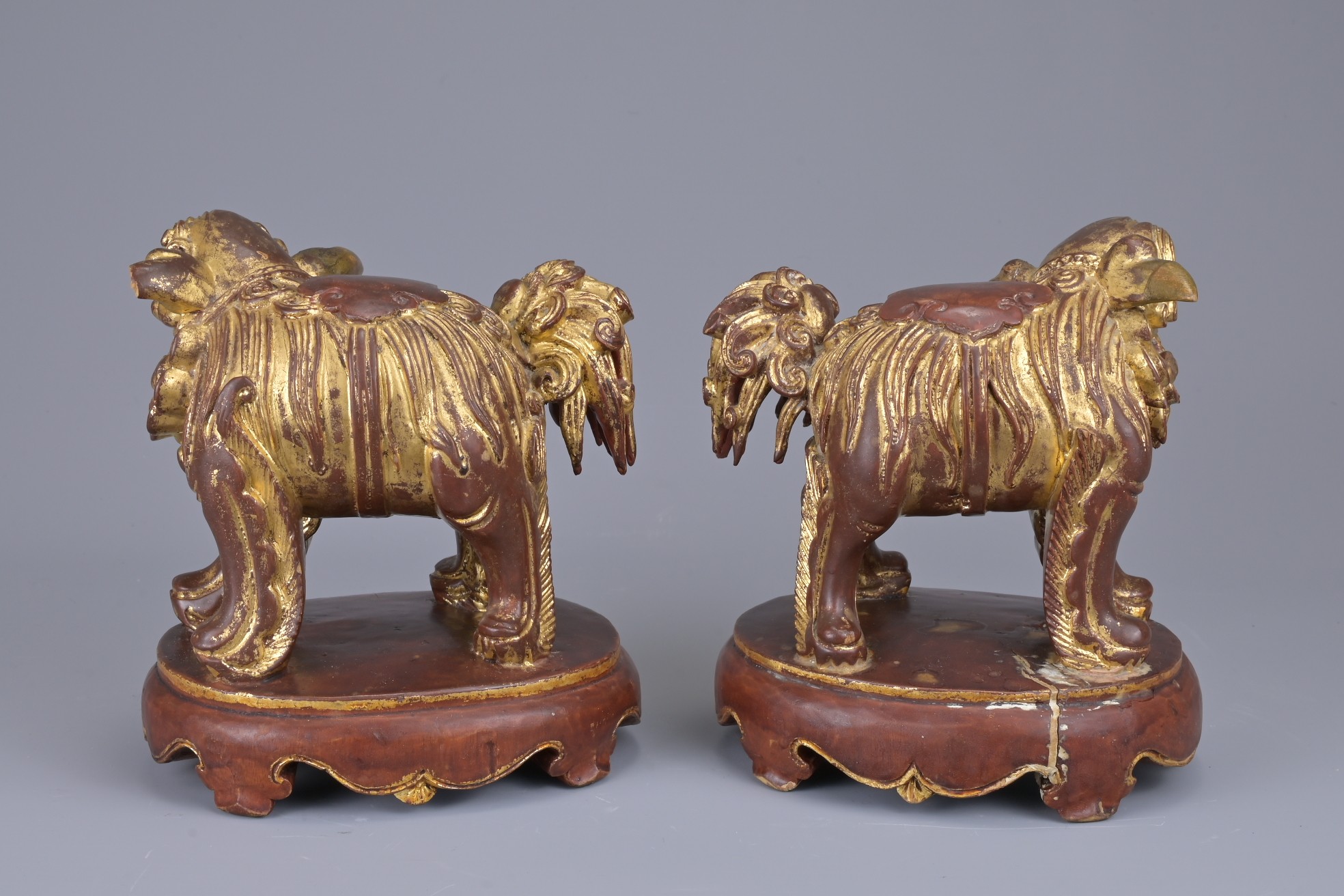 A PAIR OF CHINESE CARVED WOOD GILT LACQUERED LIONS. Standing fiercely with bushy tail. Ruyi head - Image 3 of 6