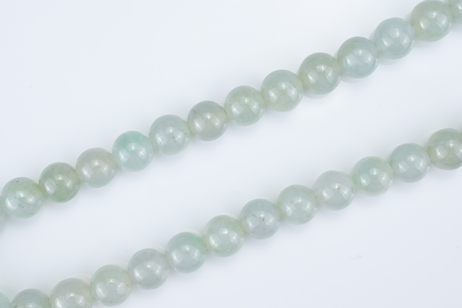 A PALE GREEN JADEITE SINGLE STRAND BEADED NECKLACE WITH 18KT YELLOW GOLD CLASP. The marquise- - Image 7 of 7