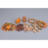 A COLLECTION OF ASSORTED PIECES OF NATURAL AMBER, AMBER BEADS AND AMBER COLOURED BEADS. Including: