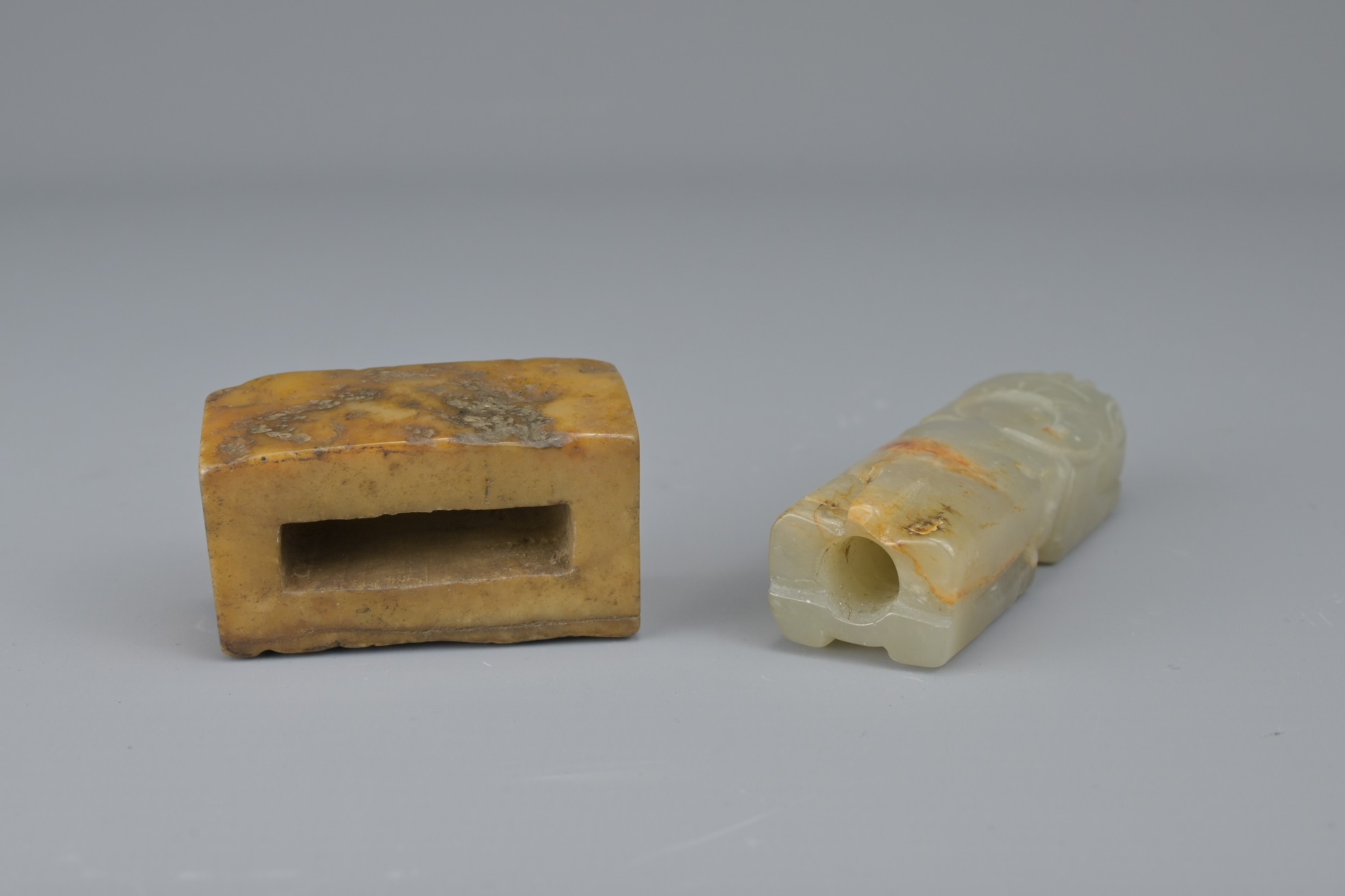 TWO CHINESE JADE FITTINGS. To include a celadon and russet animal form section of cylindrical - Image 3 of 6