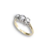 AN 18CT GOLD PLATINUM DIAMOND RING. Three round cut diamonds in a row mounted in platinum setting