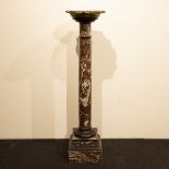 Marble pedestal with bronze top.