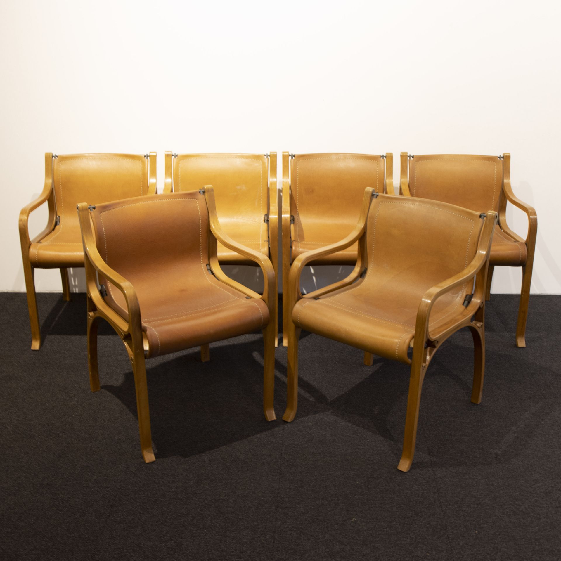 A set of six armchairs by Cristian Valdes, 'model B', leather, steel tubing and laminated wood, desi