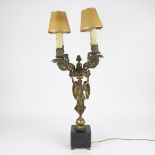 A tall bronze candelabra with Caryatid angel