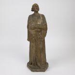 A patinated sculpure of a scholar in a toga