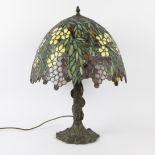 Bronze lamp Tiffany style, shade with colorful flower and leaf motif