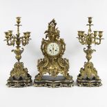 A three-part Louis XV style gilt bronze mantel clock garniture consisting of a clock and candlestick