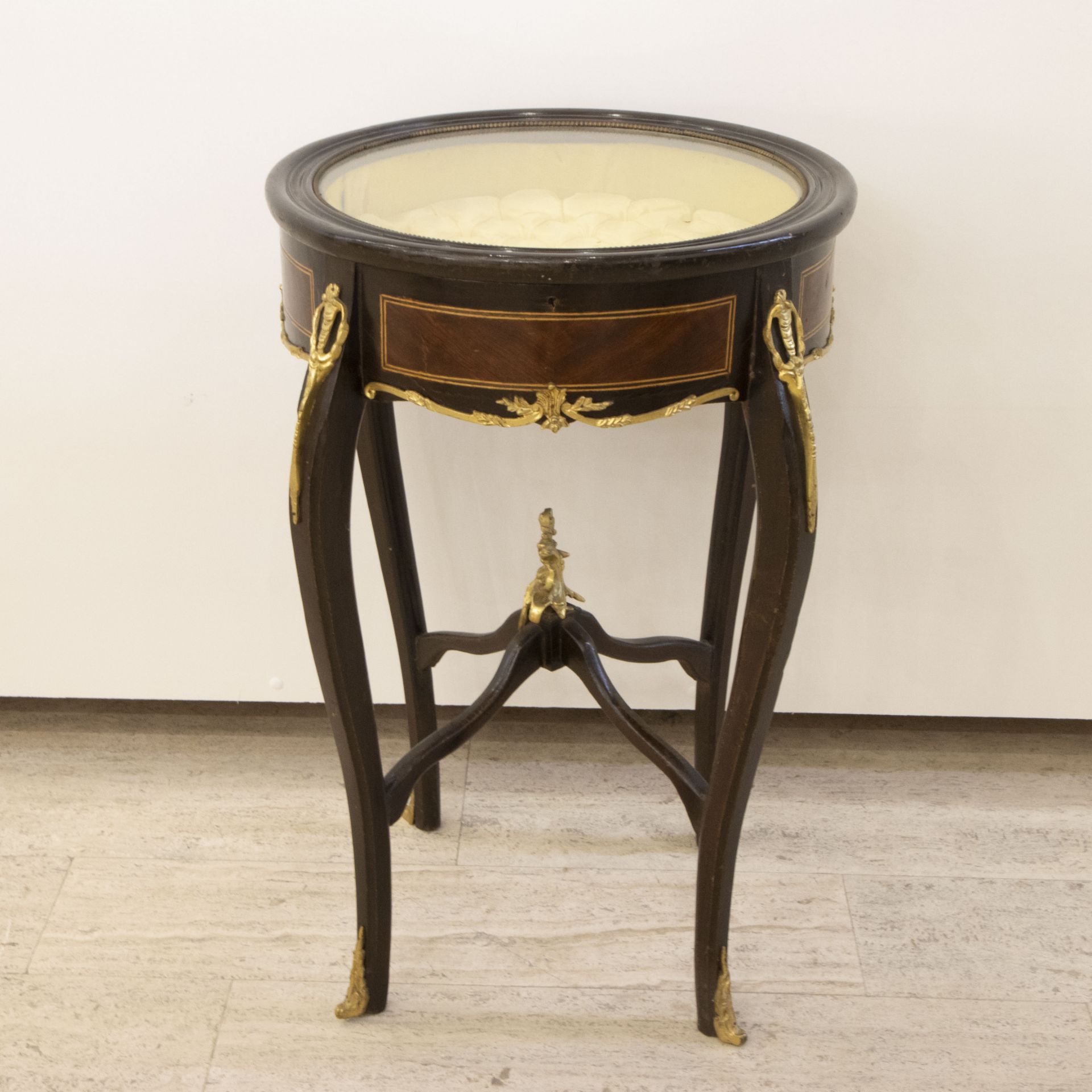 Round display cabinet with bronze fittings