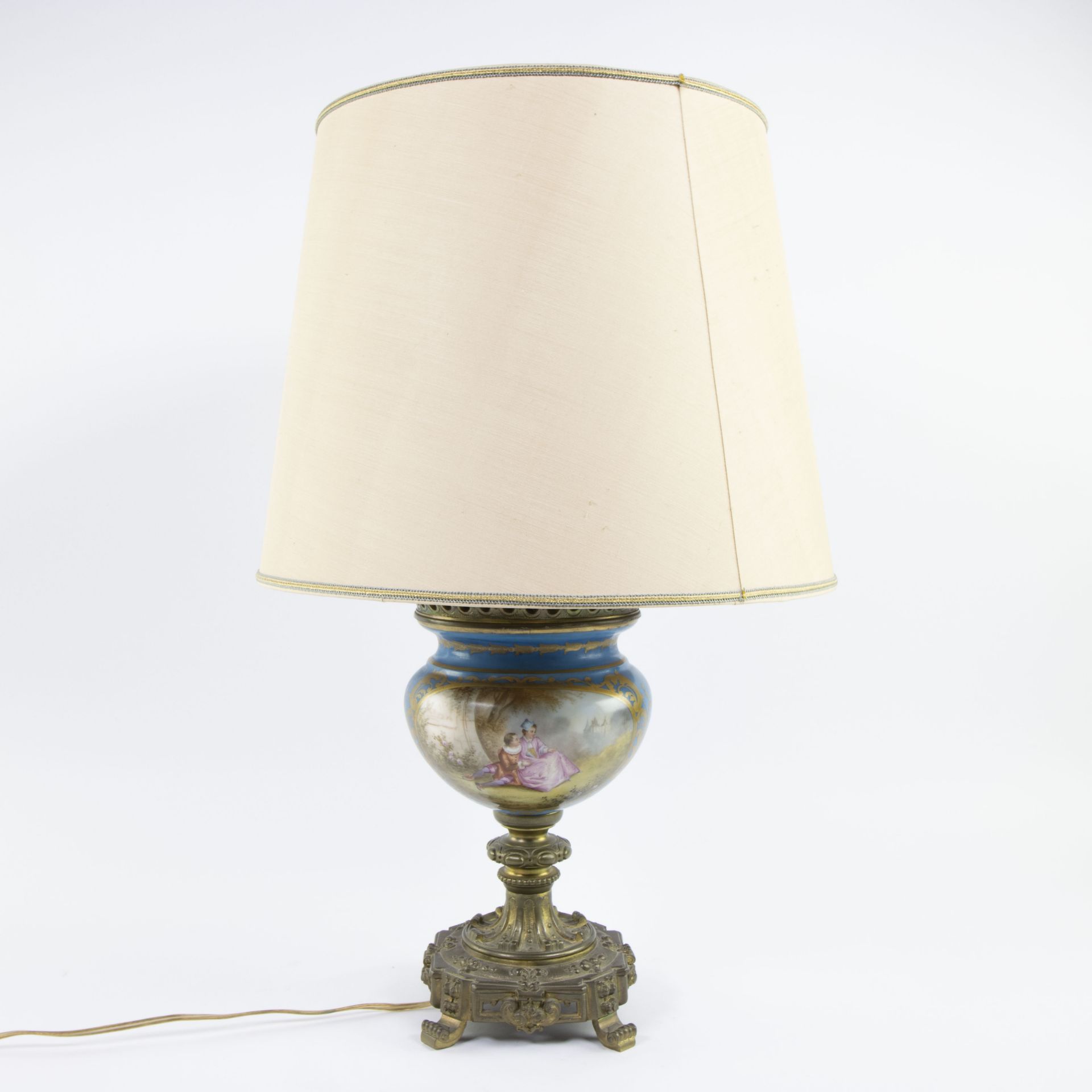 Vase of Sèvres porcelain with hand-painted decor with gilt bronze base. Mounted as lamp.