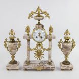 Louis XVI style, mantle garniture comprising a clock in brass with marble columns and two matching c
