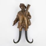 Antique hand-carved wooden Black Forest hunter with chamois horns as whipe hook