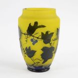 Vase in yellow glass paste decorated with brown leaf motif, signed