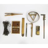 Collection of miscellaneous items including hat and shoe size gauge, glove pliers, surveyors' tools,