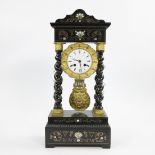 Napoleon III period clock with four twisted columns in black wood with brass inlay.