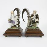 Pair of porcelain inkwells depicting Voltaire and Rousesau on a wooden base circa 1900