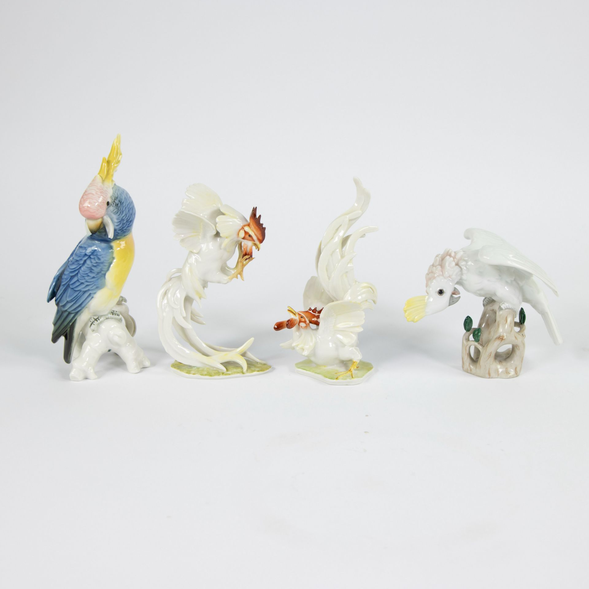A collection of 4 figurines of birds including Augarten Wien, Hutschenreuter