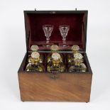 Cave a liqeur inside lined with red velvet and with 6 fine gold decorated carafes and 2 glasses