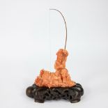 A Chinese Red Coral Sculpture On A Wooden Base depicting a fisherman circa 1900, 643 gram