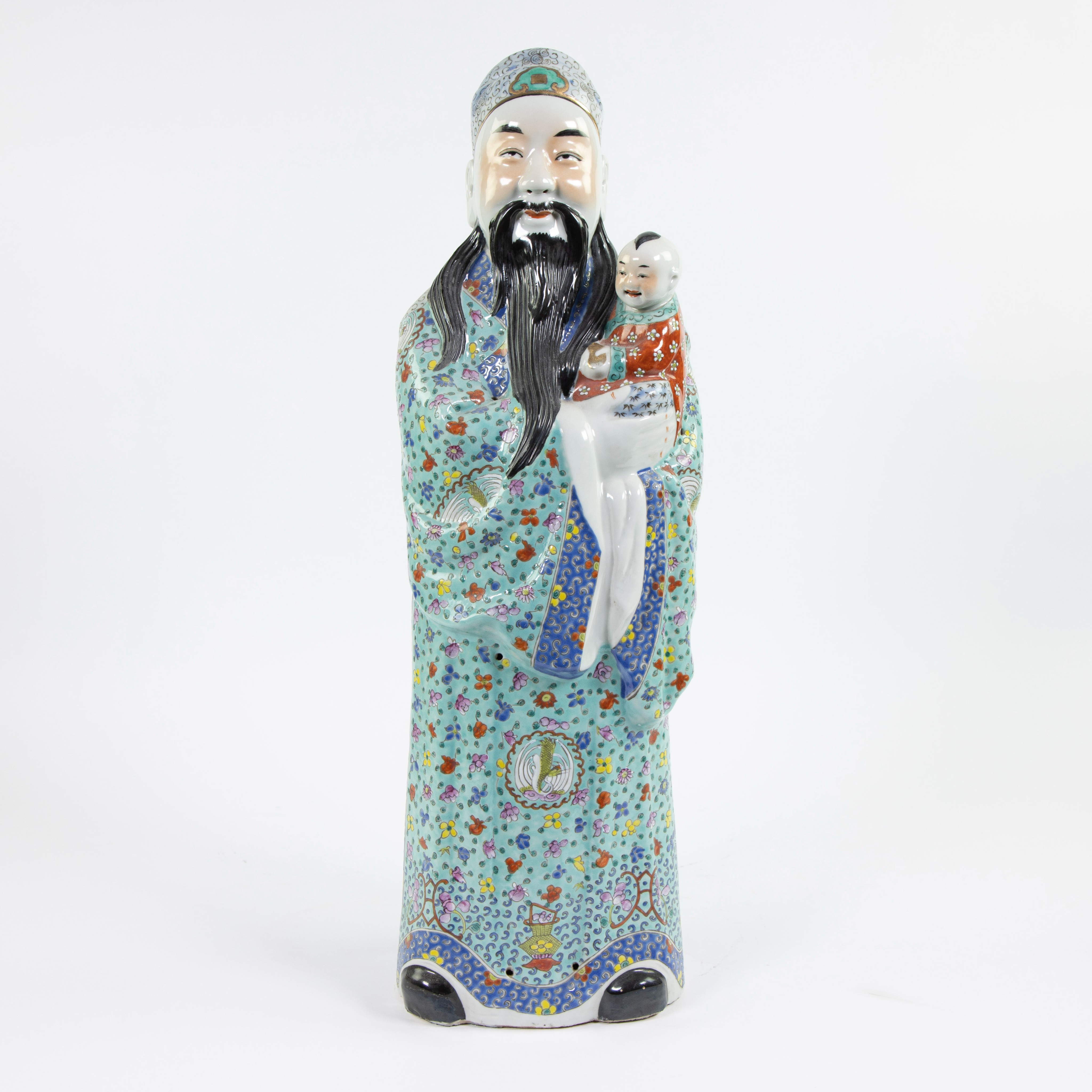 Large procelain figure of an immortal Fu Xing holding a child on his arm, stamped to the underside, 
