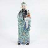 Large procelain figure of an immortal Fu Xing holding a child on his arm, stamped to the underside,